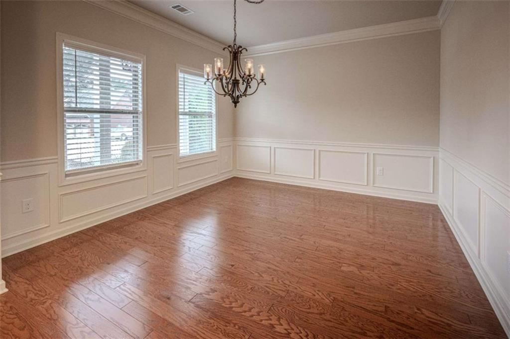 205 Heritage Stroll Athens, GA 30606 - Photo 3 of 30 wooden floor in an empty room with a window