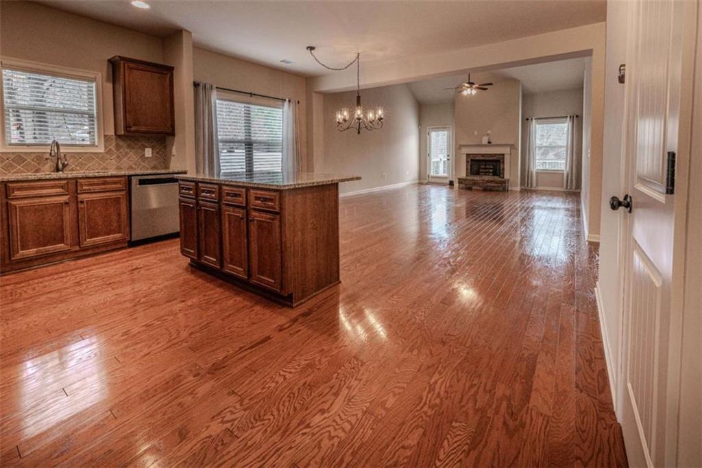 205 Heritage Stroll Athens, GA 30606 - Photo 4 of 30 a large kitchen with cabinets and wooden floor