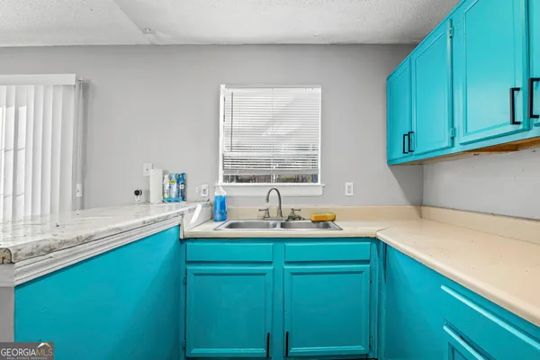 a kitchen with a sink and cabinets