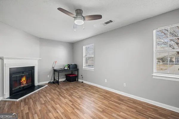 a living room with furniture and a fireplace