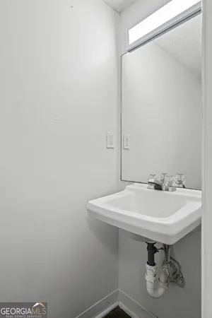 a bathroom with a sink a toilet and mirror