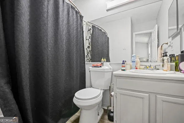 a bathroom with a sink a toilet and a mirror