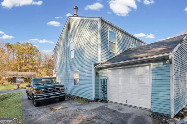 a side view of a house with a garden