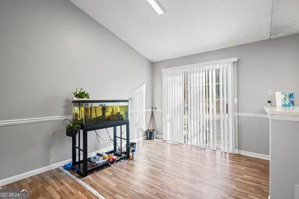 a view of a room with wooden floor and windows