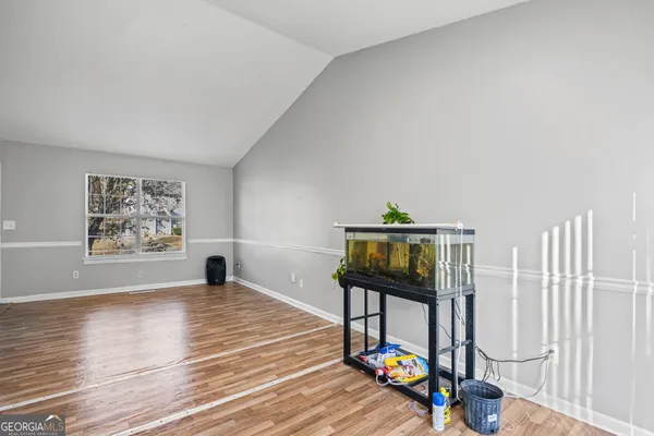 a view of a livingroom with furniture hardwood floor and a window