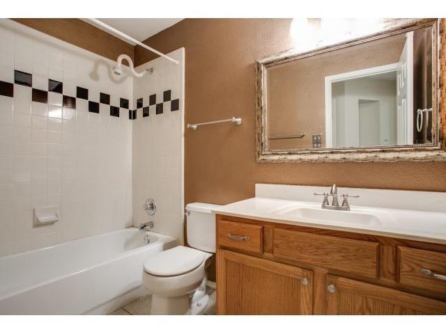 2026 Fox Glen Drive Allen, TX 75013 - Photo 12 of 17 a bathroom with a sink a toilet and a mirror