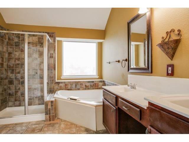 2026 Fox Glen Drive Allen, TX 75013 - Photo 14 of 17 a bathroom with a sink a mirror and a bathtub
