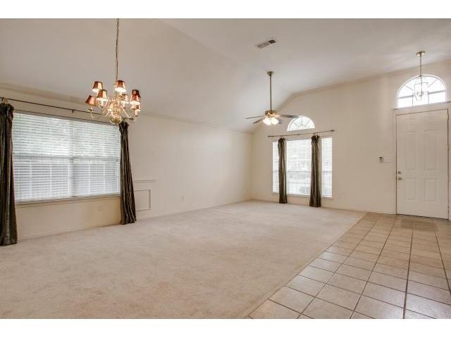 2026 Fox Glen Drive Allen, TX 75013 - Photo 3 of 17 a very nice looking room with a large window and chandelier