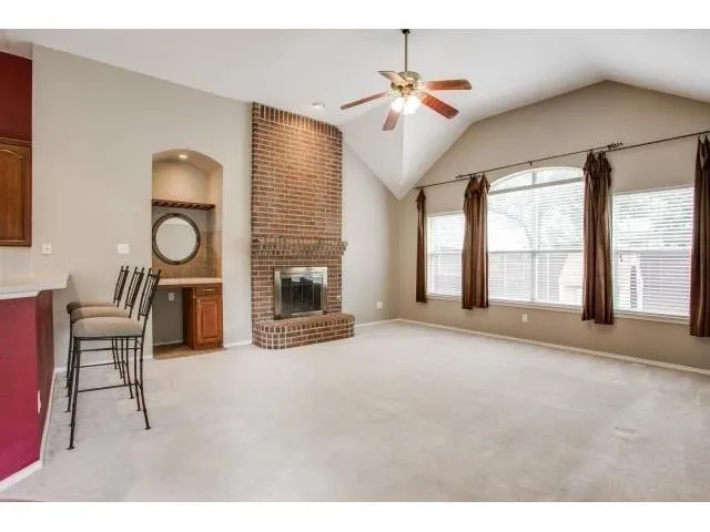 a living room with furniture a chandelier and a fireplace