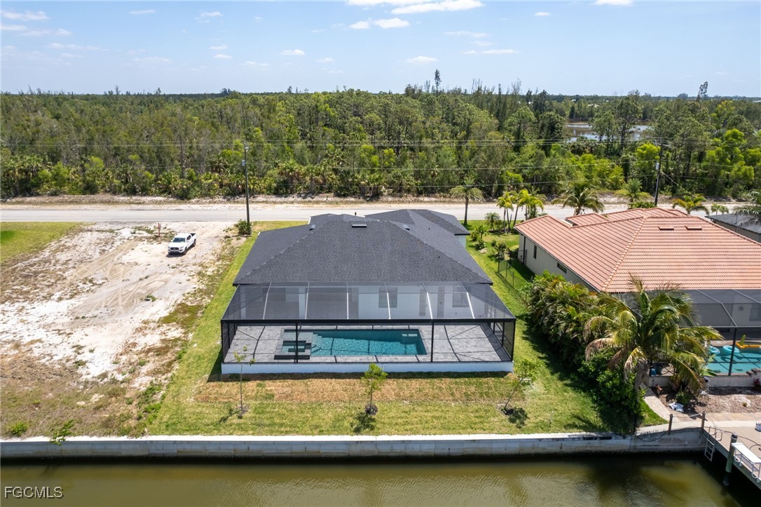 2702 Old Burnt Store Road North Cape Coral, FL 33993 - Photo 18 of 44 a view of a swimming pool with lounge chair