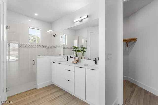 a bathroom with a double vanity sink and mirror