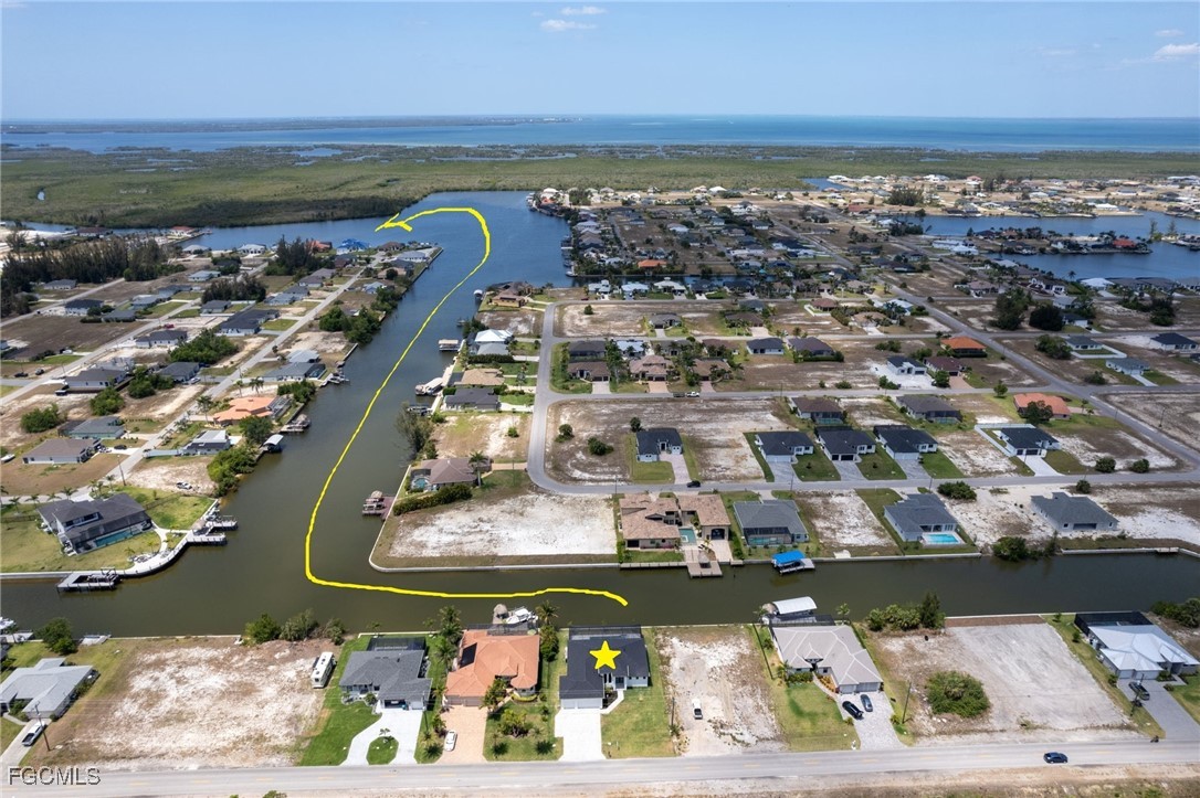 2702 Old Burnt Store Road North Cape Coral, FL 33993 - Photo 3 of 44 an aerial view of a city with lots of residential buildings ocean and mountain view in back