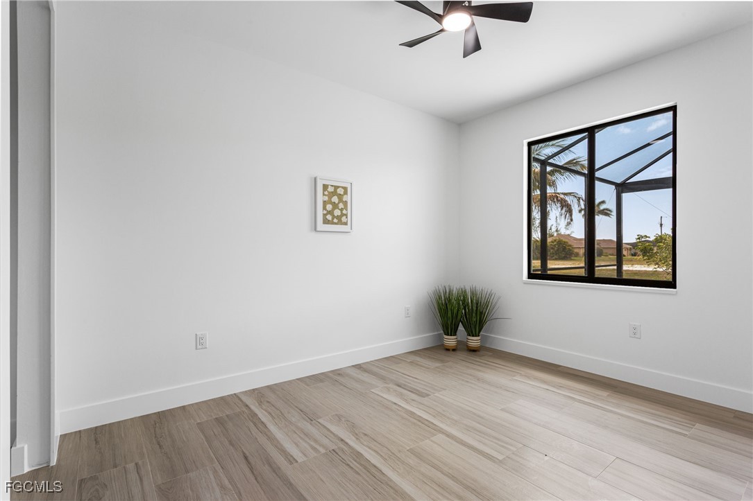 2702 Old Burnt Store Road North Cape Coral, FL 33993 - Photo 31 of 44 an empty room with a window and wooden floor