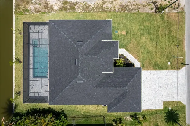 an aerial view of a house with a yard