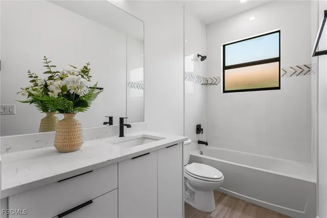 a bathroom with a toilet a sink and mirror