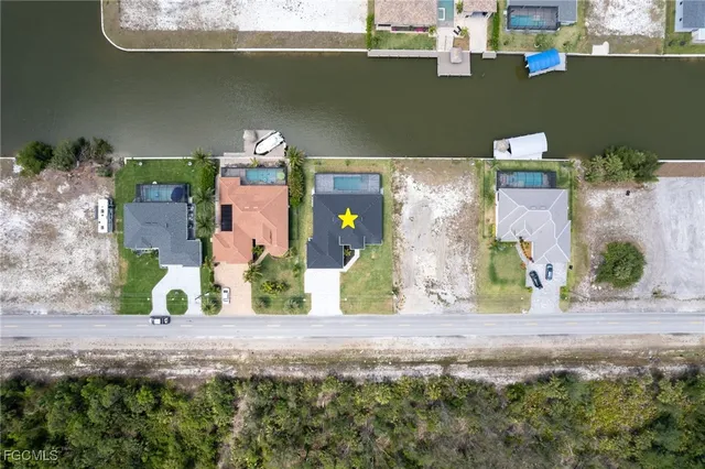 an aerial view of a house with a yard and a garage