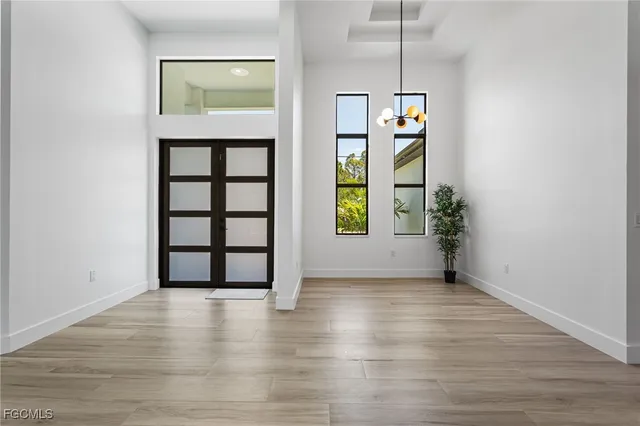 an empty room with windows and cabinet