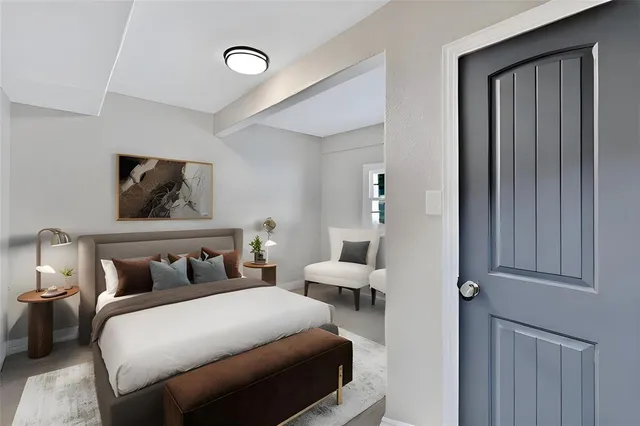 a bedroom with a bed and painting on the wall