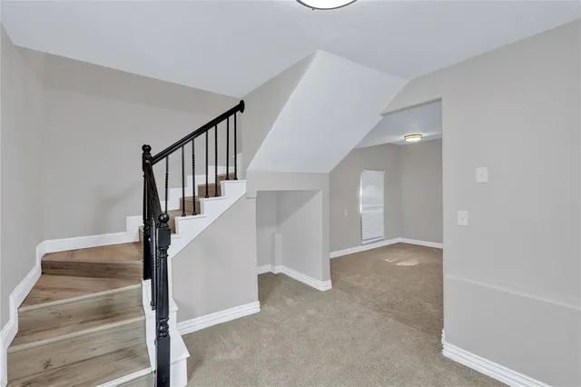 a bedroom with bed and window