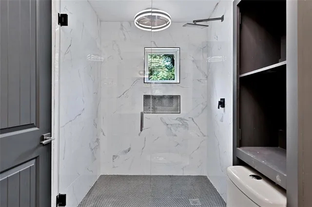 a bathroom with a window and a shower