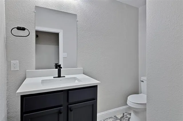 a bathroom with a sink a toilet and a mirror