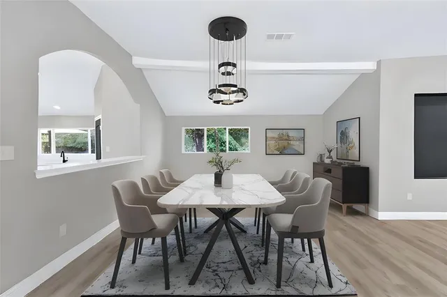 a view of a dining room with a table and chairs