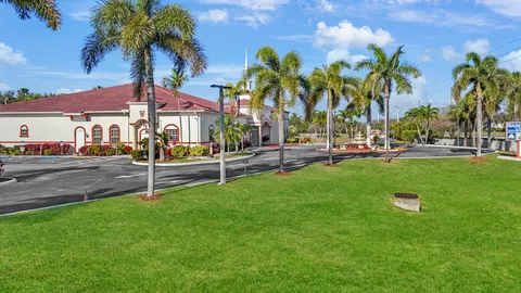 a front view of multiple houses with a yard