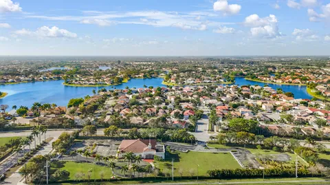 an aerial view of a city with lots of residential buildings and ocean view in back