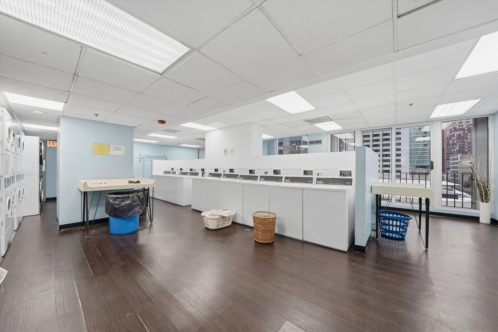 200 North Dearborn Street, Unit 906 Chicago, IL 60601 - Photo 13 of 15 a kitchen with stainless steel appliances a white cabinets and wooden floor