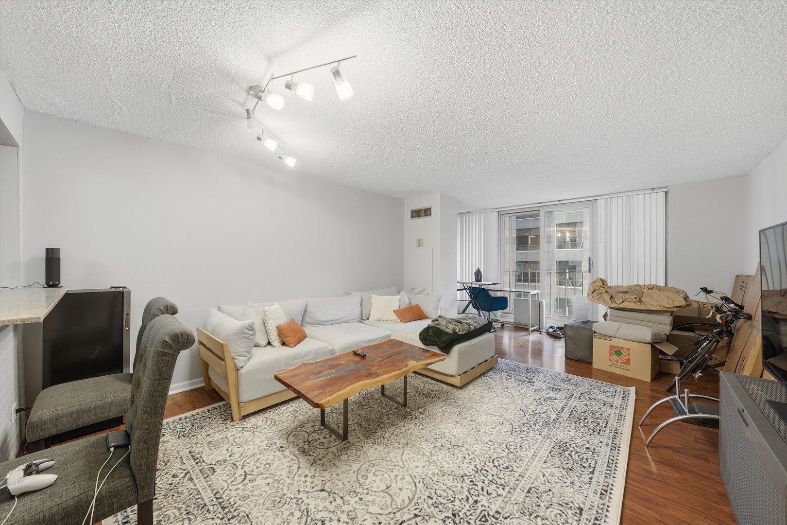 200 North Dearborn Street, Unit 906 Chicago, IL 60601 - Photo 2 of 15 a living room with furniture and a dining table with wooden floor