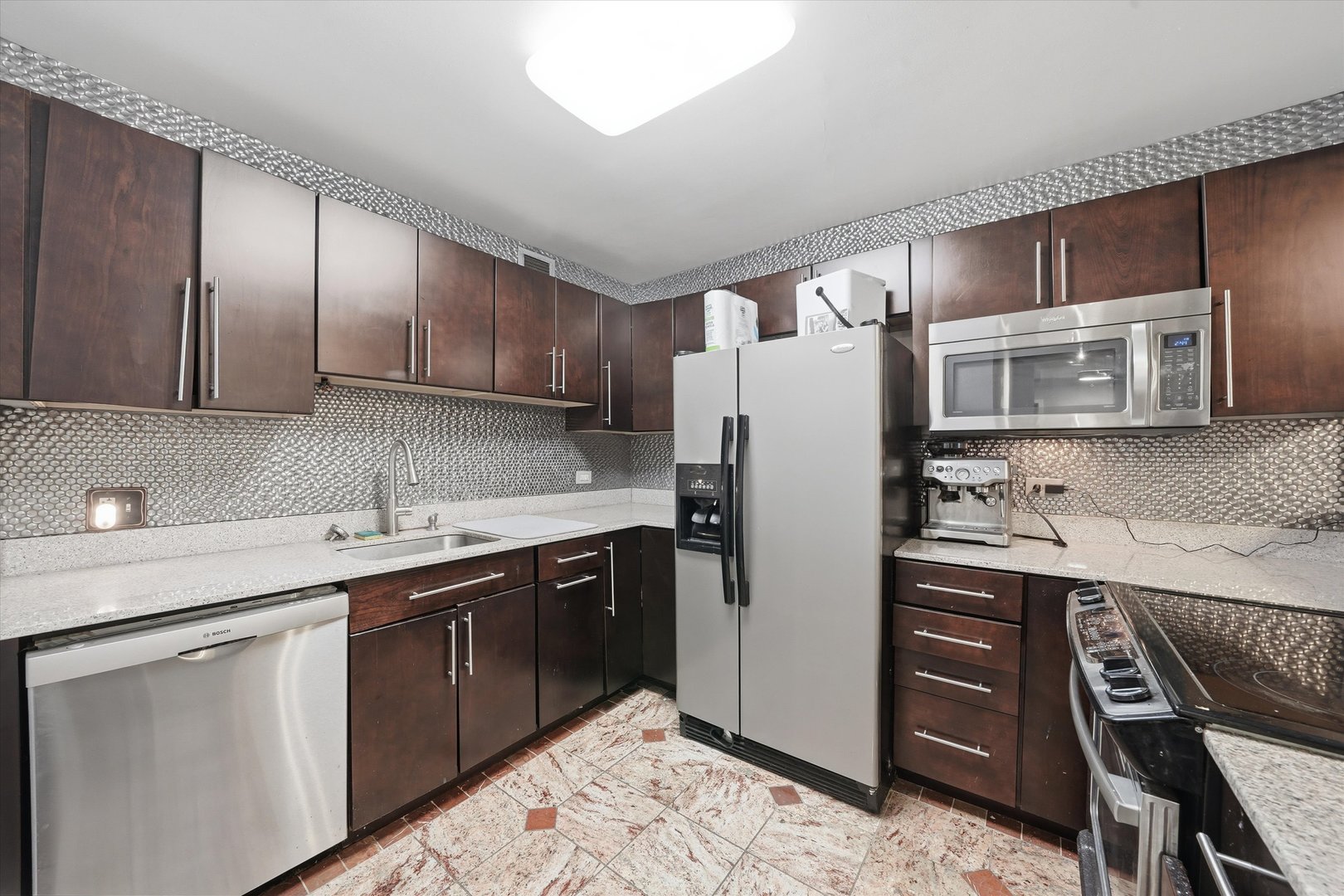 200 North Dearborn Street, Unit 906 Chicago, IL 60601 - Photo 4 of 15 a kitchen with stainless steel appliances granite countertop a refrigerator and a sink
