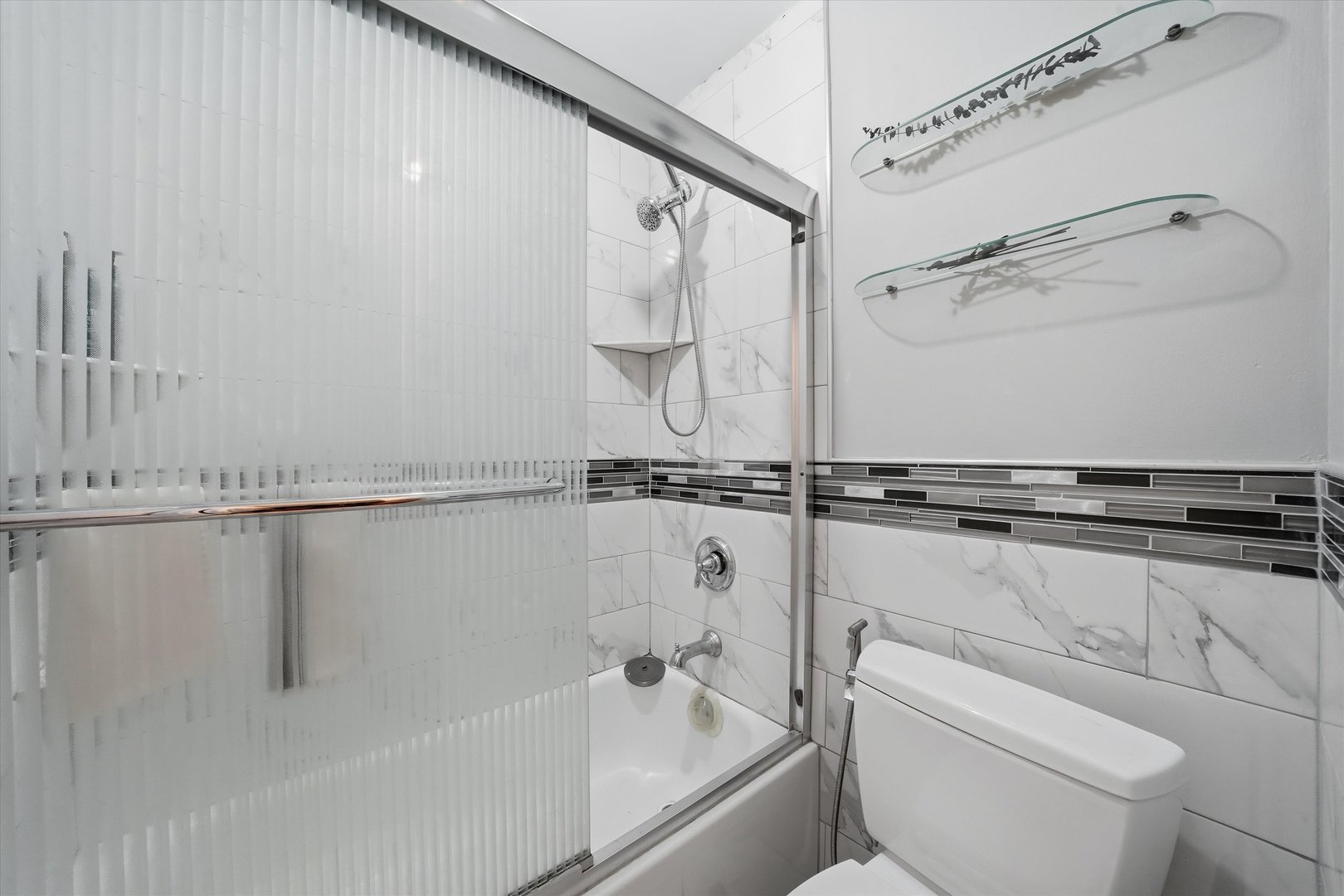 200 North Dearborn Street, Unit 906 Chicago, IL 60601 - Photo 6 of 15 a bathroom with a shower a toilet and sink
