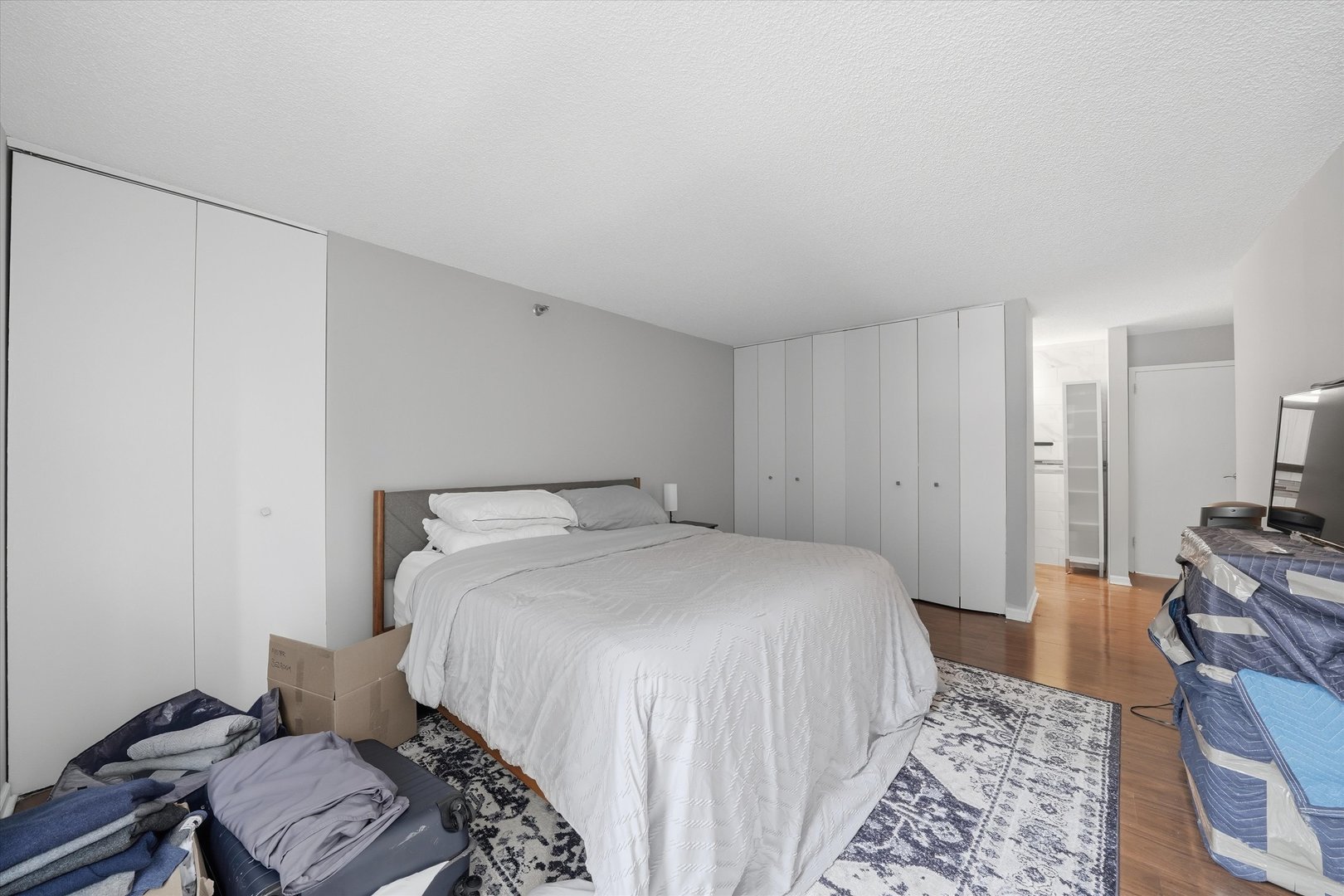 200 North Dearborn Street, Unit 906 Chicago, IL 60601 - Photo 8 of 15 a bedroom with a bed and wooden floor