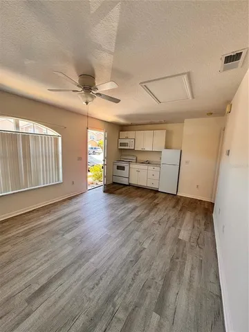 a view of a livingroom with hardwood floor and a ceiling fan