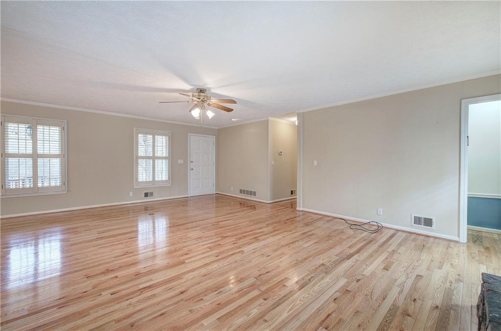 408 Mac Johnson Road Northwest Cartersville, GA 30121 - Photo 12 of 62 an empty room with wooden floor and windows