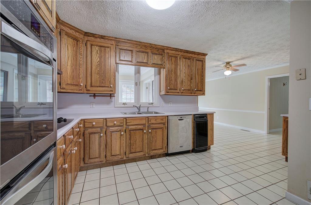 408 Mac Johnson Road Northwest Cartersville, GA 30121 - Photo 16 of 62 a kitchen with stainless steel appliances granite countertop a sink and cabinets