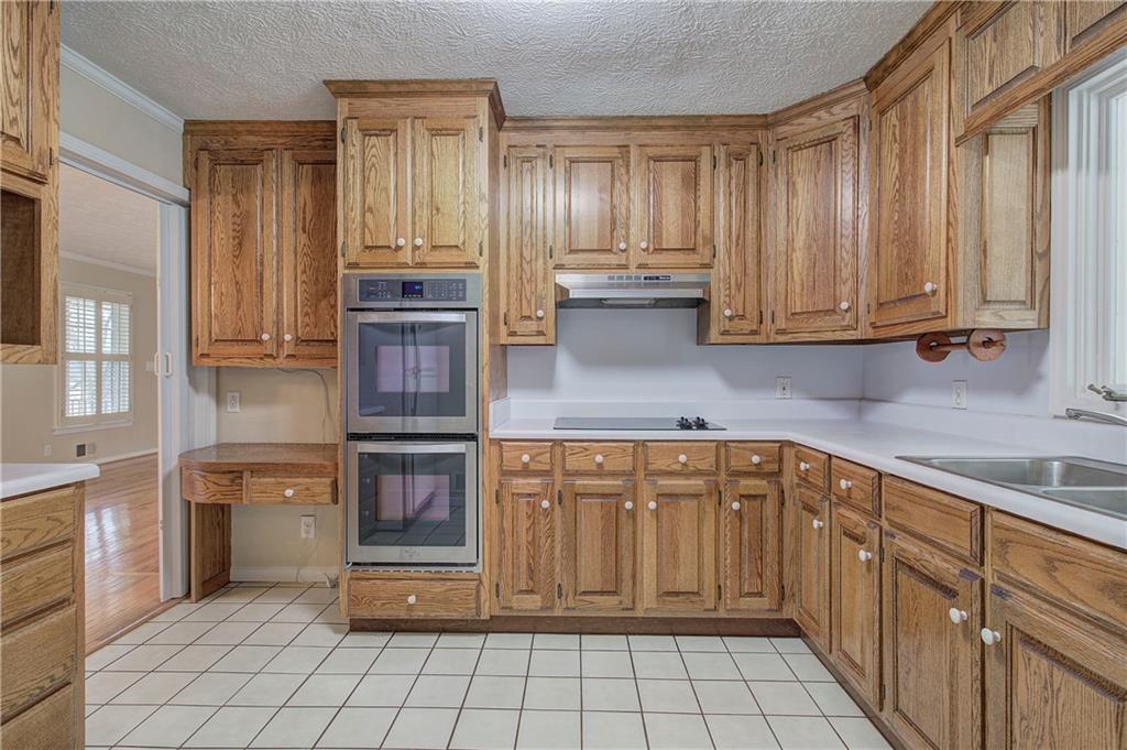 408 Mac Johnson Road Northwest Cartersville, GA 30121 - Photo 17 of 62 a kitchen with stainless steel appliances granite countertop a stove and cabinets