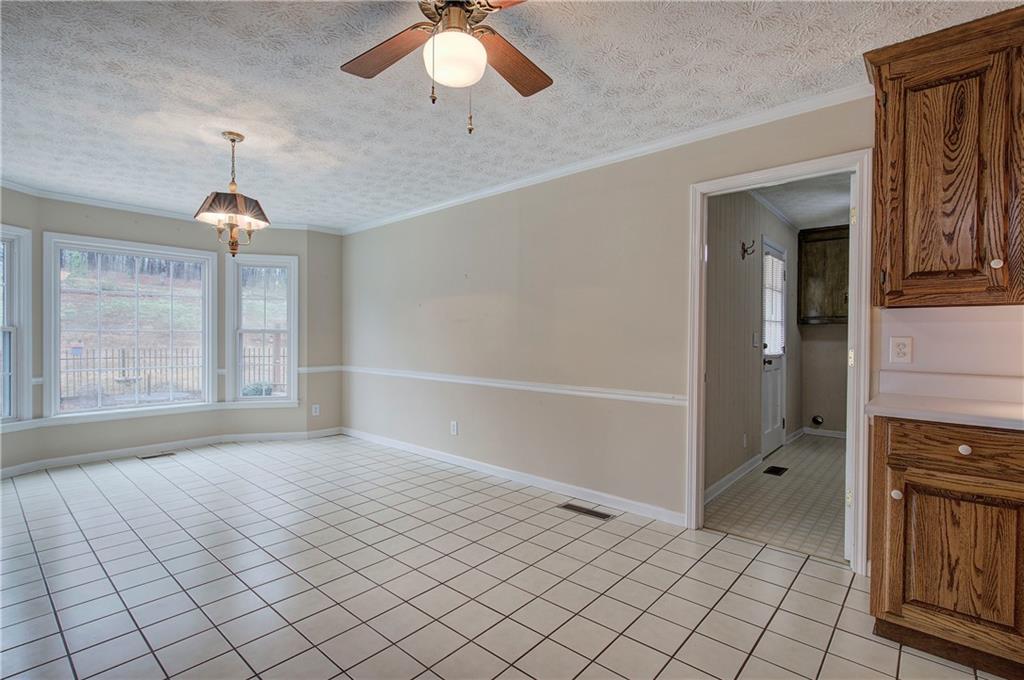 408 Mac Johnson Road Northwest Cartersville, GA 30121 - Photo 19 of 62 an empty room with windows and chandelier