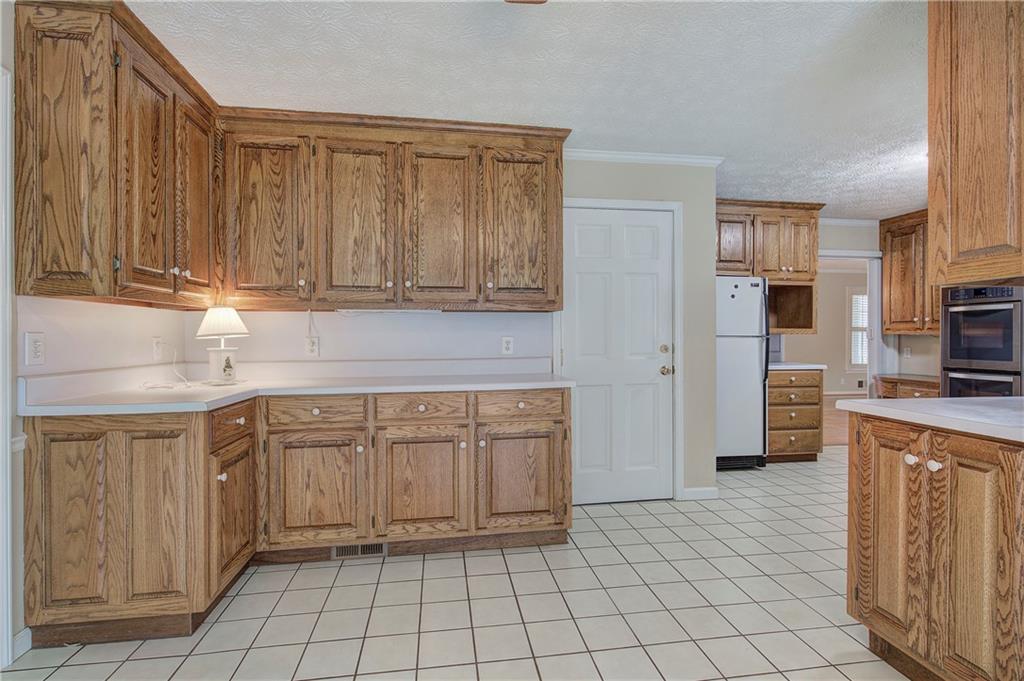 408 Mac Johnson Road Northwest Cartersville, GA 30121 - Photo 20 of 62 a kitchen with stainless steel appliances granite countertop a sink and cabinets
