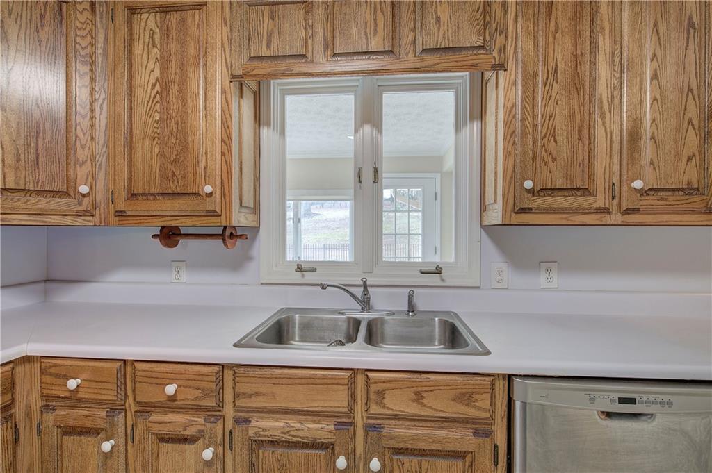 408 Mac Johnson Road Northwest Cartersville, GA 30121 - Photo 22 of 62 a kitchen with granite countertop a sink and cabinets