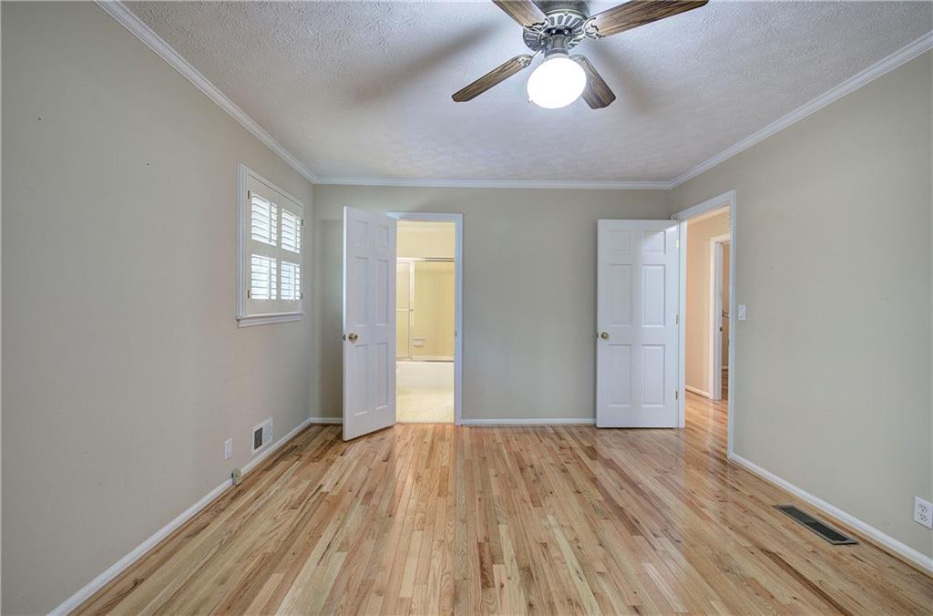 408 Mac Johnson Road Northwest Cartersville, GA 30121 - Photo 35 of 62 an empty room with wooden floor fan and windows