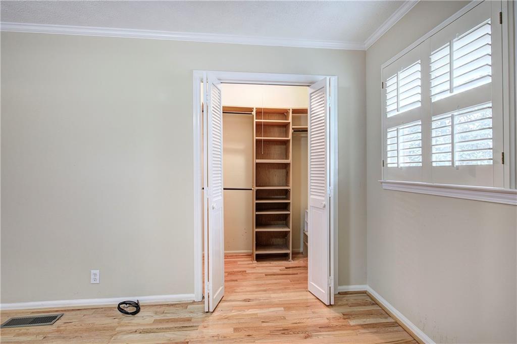 408 Mac Johnson Road Northwest Cartersville, GA 30121 - Photo 36 of 62 a view of an empty room with wooden floor and windows