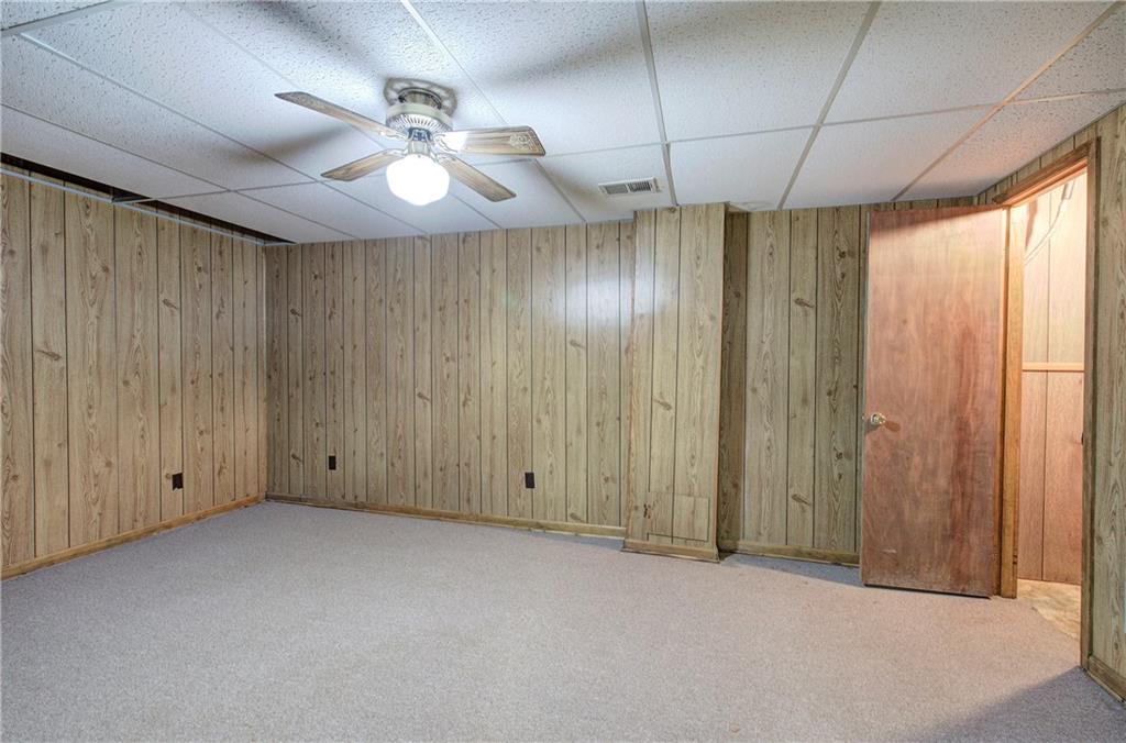 408 Mac Johnson Road Northwest Cartersville, GA 30121 - Photo 45 of 62 an empty room with a chandelier fan and windows