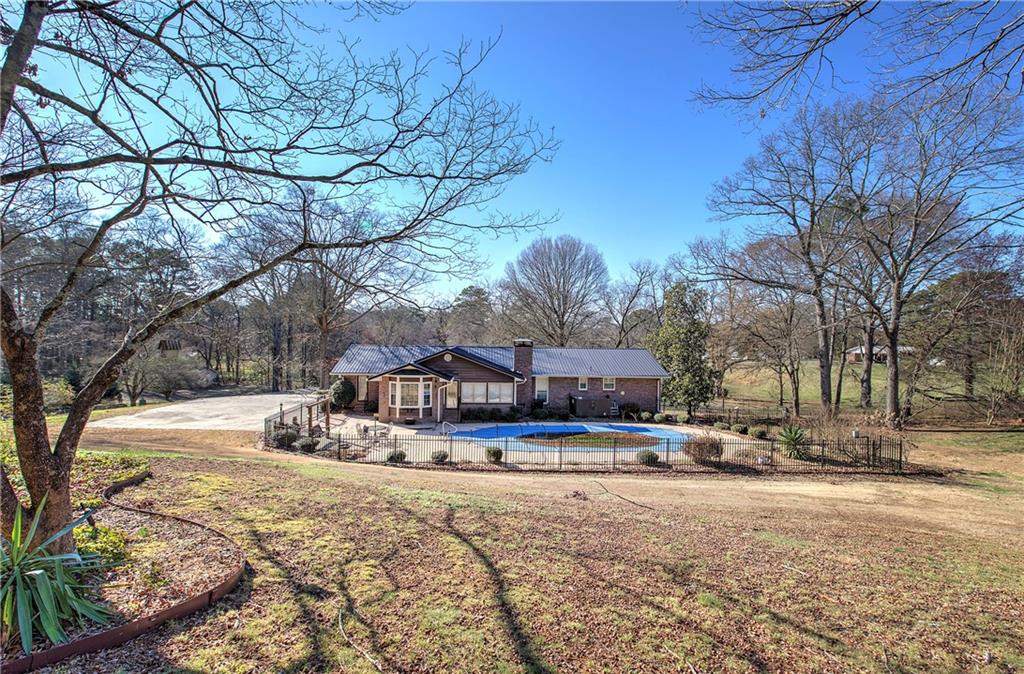 408 Mac Johnson Road Northwest Cartersville, GA 30121 - Photo 54 of 62 a view of a white house with a yard covered in snow