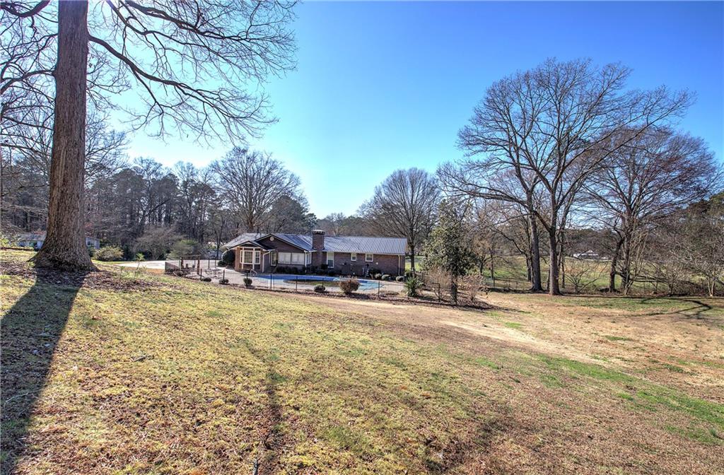 408 Mac Johnson Road Northwest Cartersville, GA 30121 - Photo 56 of 62 a view of a yard with a tree