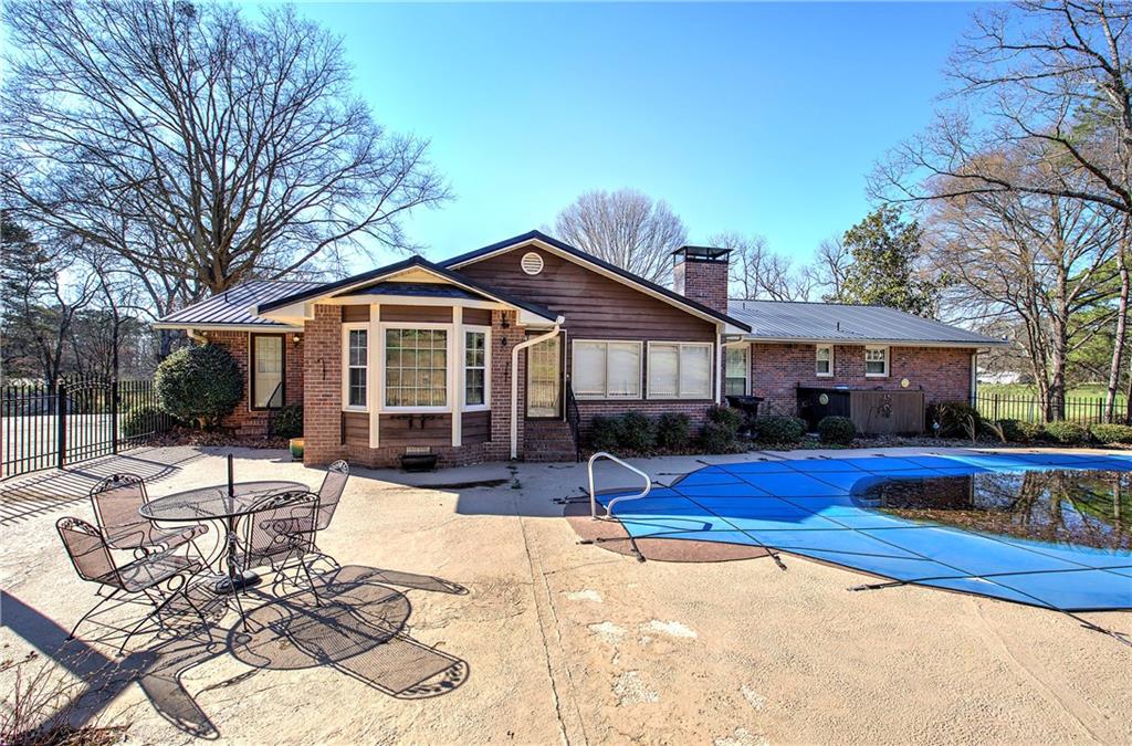 408 Mac Johnson Road Northwest Cartersville, GA 30121 - Photo 59 of 62 a front view of a house with yard patio and fire pit