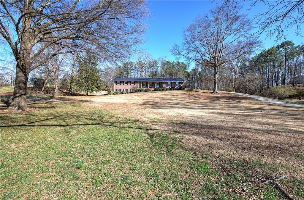 408 Mac Johnson Road Northwest Cartersville, GA 30121 - Photo 6 of 62 a view of a yard with a large tree