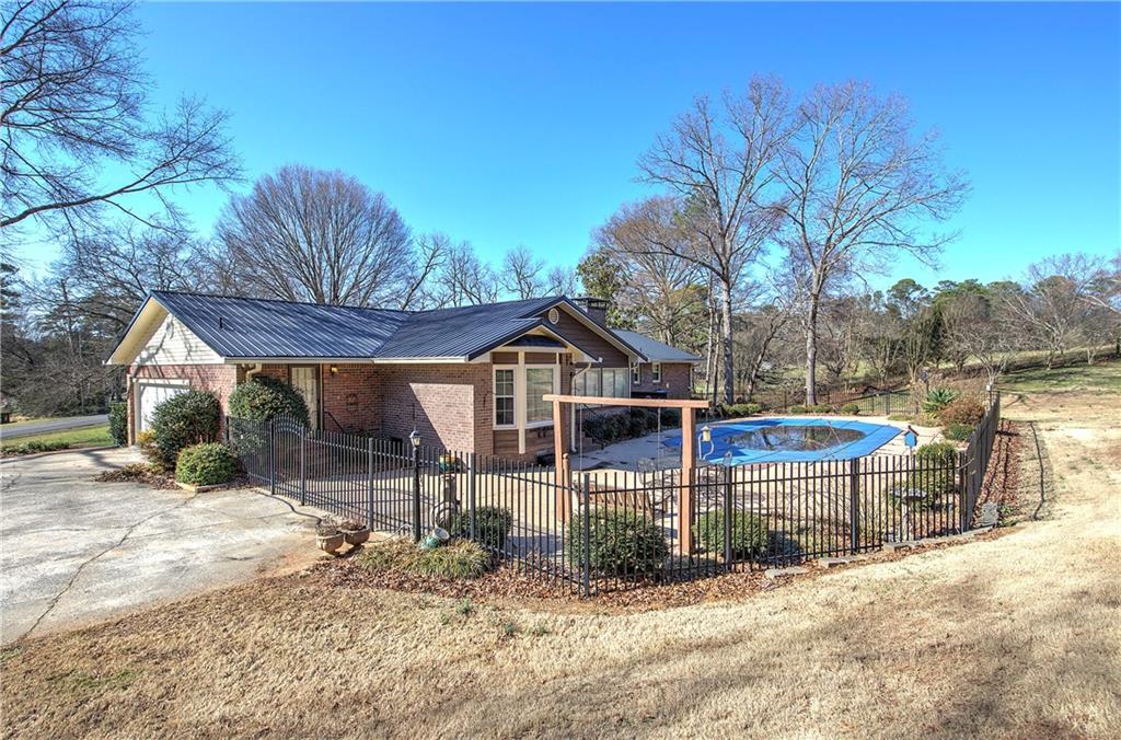 408 Mac Johnson Road Northwest Cartersville, GA 30121 - Photo 7 of 62 a view of a house with a yard