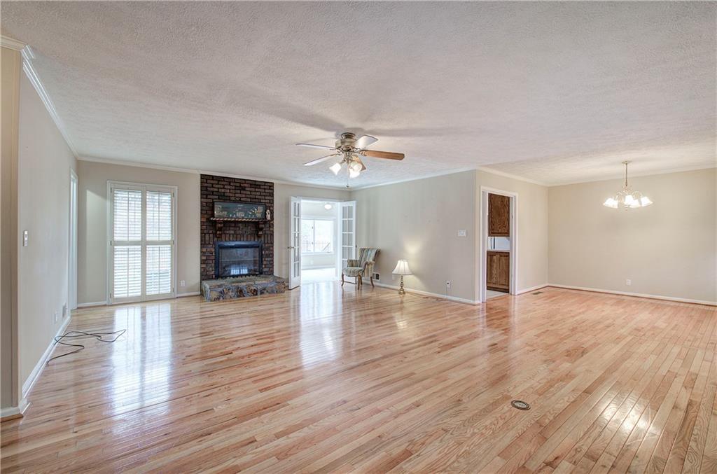 408 Mac Johnson Road Northwest Cartersville, GA 30121 - Photo 9 of 62 a view of an empty room with wooden floor and a window