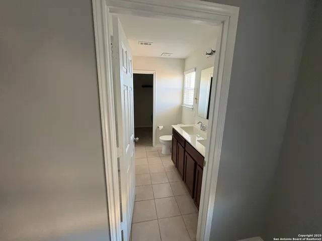 a hallway with a sink and a stove
